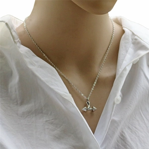 Minimalist silver dumbbell pendant necklace for women worn on neck with O-chain