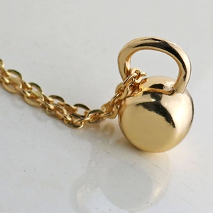 Polished gold kettlebell pendant necklace for fitness lovers with minimalist link chain