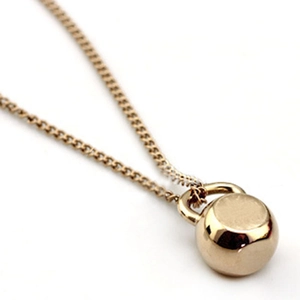 Polished champagne gold kettlebell pendant necklace for fitness lovers on a white background