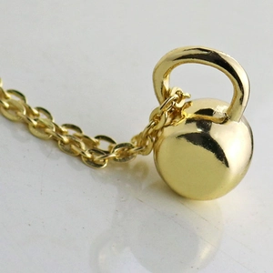 Polished gold kettlebell pendant necklace for women with a classic O-link chain