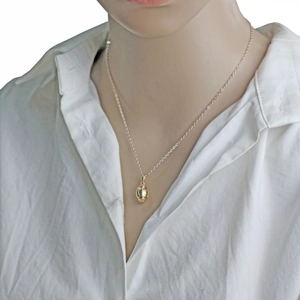 3D American football pendant necklace in champagne gold on a model for sports lovers