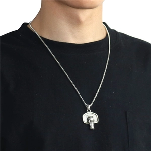 Hip hop basketball hoop pendant necklace in silver finish worn on black t-shirt