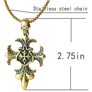 Detailed view of gothic gold cross pendant with skull motif and dimension markings