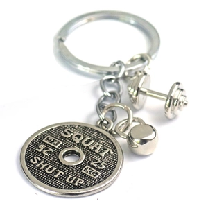 Portachiavi fitness in metallo argento con mini bilanciere e disco pesi per squat