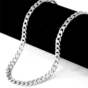 Macro detail of polished silver stainless steel Cuban link necklace for men