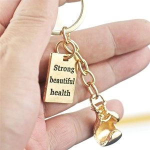 Goldener Boxhandschuh Schlüsselanhänger mit Strong Beautiful Health Gravur auf Metall