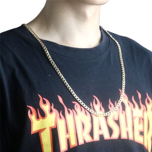 Flat curb chain link detail shown on model neck in a high-polished golden finish