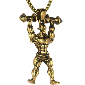 Macro shot of gold muscular bodybuilder dumbbell pendant necklace with gold ball chain