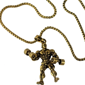 Macro shot of gold muscular bodybuilder pendant holding dumbbell with box chain