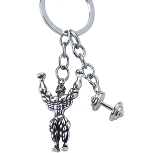 Detailed view of silver-toned fitness keychain with bodybuilder and dumbbell charms
