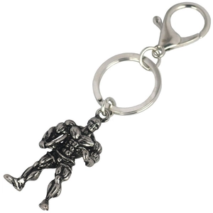 Macro detail of a bodybuilding keychain showing muscle texture and vintage silver finish