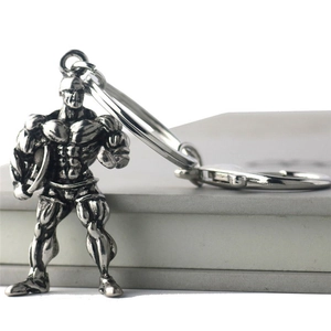Antique silver muscular bodybuilder metal keychain with detailed fitness physique