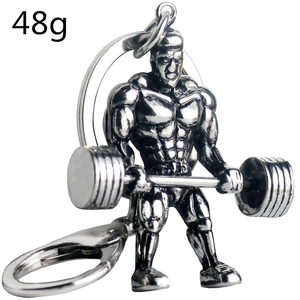 Close-up of 48g silver muscular man figurine keychain holding a barbell for fitness