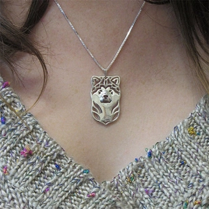 Silver hollow husky dog head pendant necklace with intricate Celtic knot art on a chain
