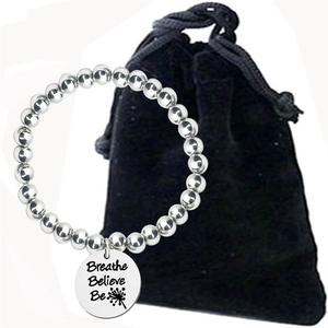Engraved silver beaded bracelet with 'Breathe Believe Be' pendant and velvet bag