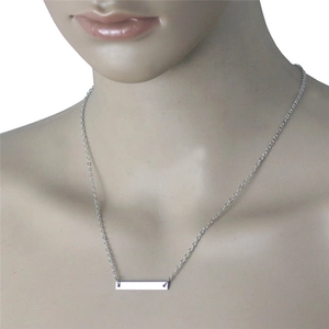 Minimalist silver stainless steel bar pendant necklace displayed on a mannequin neck