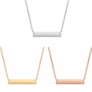 Close-up of minimalist vertical bar necklaces in silver, gold and rose gold finishes