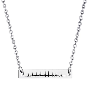 Detailed view of silver stainless steel rectangle pendant with heartbeat engraving