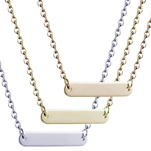 Detail view of polished rectangle bar pendants in gold, silver and rose gold steel