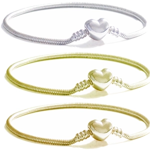 Three snake bone chain bracelets with heart-shaped clasps in silver and gold metal finishes