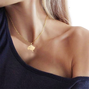 Gold-tone brain stem pendant necklace on a delicate chain worn by a female model