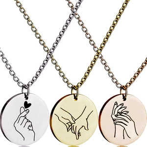 Detailed view of silver, gold, and rose gold pendants with minimalist line art engravings
