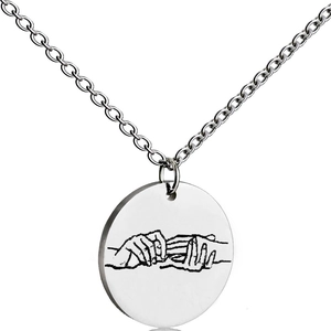 Detailed view of silver stainless steel pendant featuring a hand promise engraving