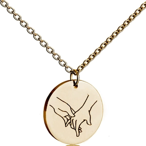 Detail of gold circle pendant with engraved hand-holding line art on O-chain necklace