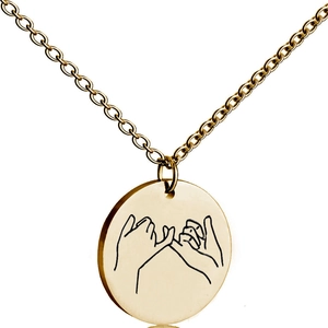 Detailed close-up of a gold disc pendant featuring an engraved pinky swear gesture