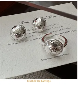 Detailed view of S925 silver earrings with crushed ice texture and woven borders