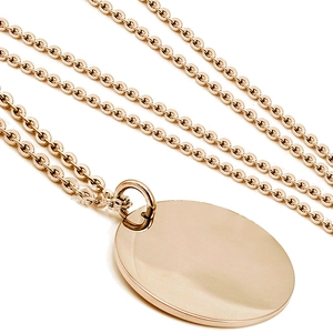Macro detail of rose gold cable chain with a high-polished round disc pendant