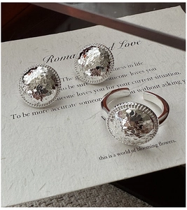Detail of S925 silver earring and ring set with hammered texture and rope edge border