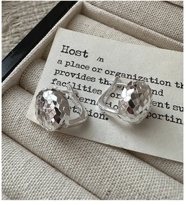 Macro shot of S925 sterling silver hoop earrings with faceted sphere design in jewelry box