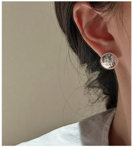 Close-up of S925 sterling silver earring with unique crushed ice texture on a model
