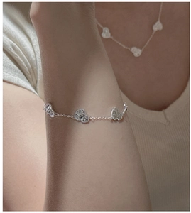 Detailed view of S925 sterling silver heart bracelet with sparkling zircon on a model wrist