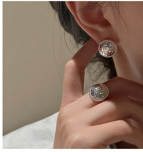 Close-up of model wearing S925 silver ice-crushed texture earrings and ring set