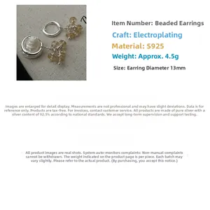 Detail view of S925 sterling silver hoop earrings with yellow citrine and white pearl beads