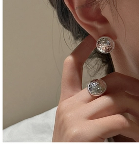 Close-up of S925 silver round stud earrings and ring set with sparkling crushed ice pavé