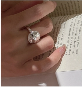 Macro detail of silver S925 ring with textured hammer finish and beaded edges on model