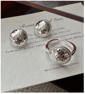 Detail of S925 silver jewelry set featuring hammered texture rings and stud earrings