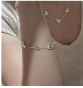 Close-up of S925 sterling silver heart bracelet worn on wrist with elegant matte finish