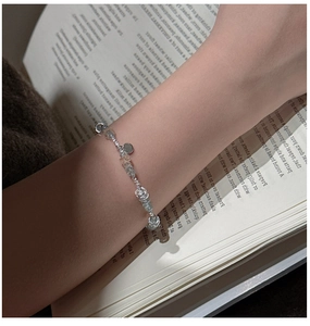 Detail of beaded S925 silver bracelet with blue aquamarine style crystals on a model