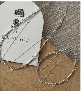 Detail of S925 silver beaded bracelet with clear crystals and heart charm pendant