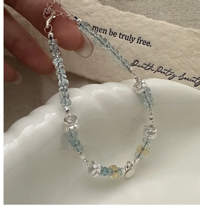 Detail of S925 sterling silver bracelet with light blue beads and textured metal accents