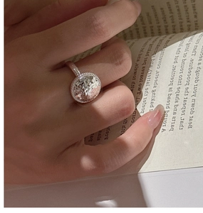 Close-up of S925 sterling silver ring with hammered texture and beaded edge design