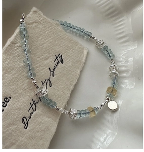 Detailed shot of S925 silver beaded bracelet with light blue aquamarine and carved spacers