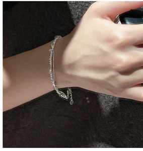 Close-up of double-layer S925 silver beaded bracelet with heart charm on a wrist