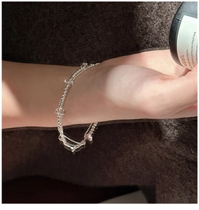Detailed close-up of a double-layer S925 sterling silver beaded bracelet with white crystals