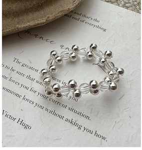 Macro shot of S925 sterling silver beaded ring with clear crystals on vintage paper
