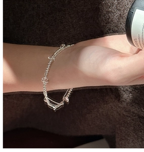 Close-up of double-layer S925 silver beaded bracelet with clear faceted crystals